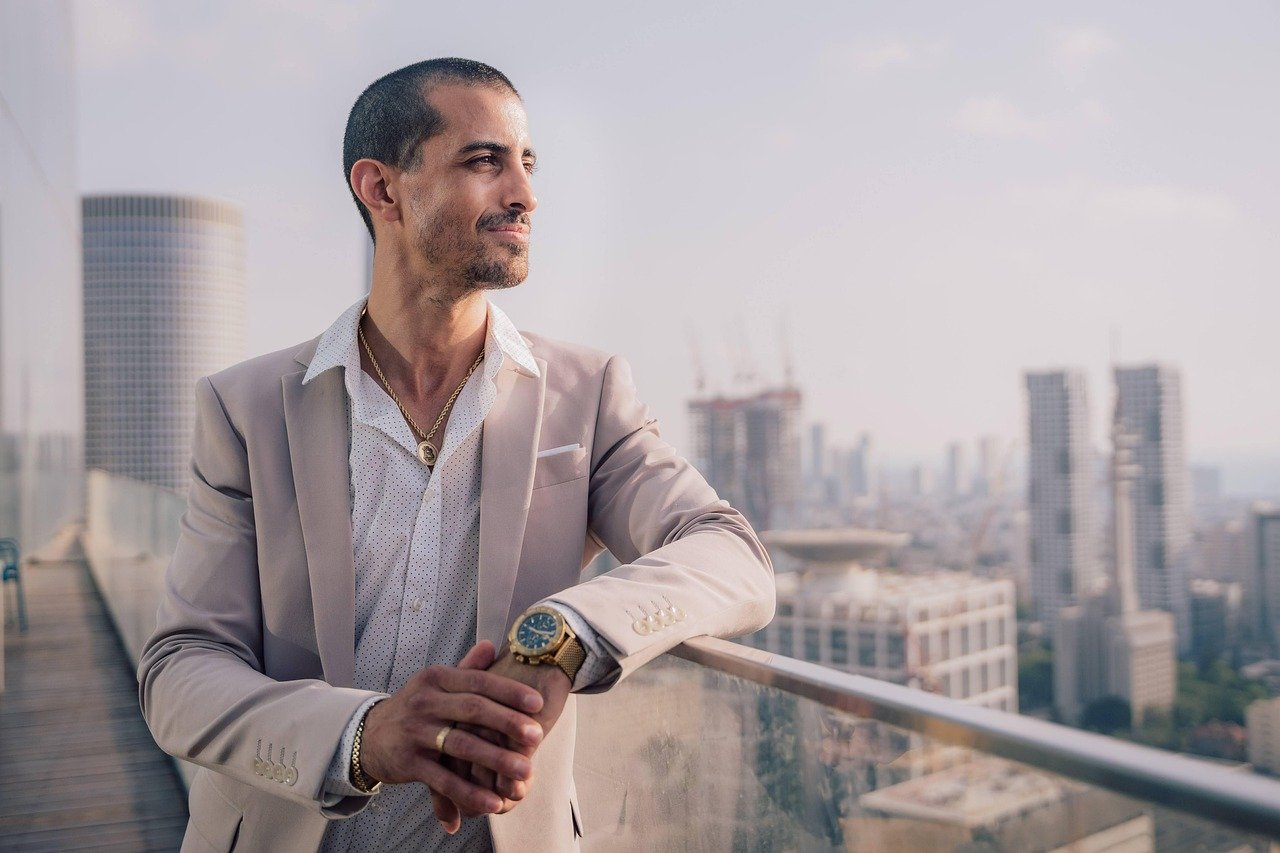 male, model, portrait, man, face, male model, black shirt, smile, smiling, smiling man, modeling, pose, posing, studio photography, male portrait, guy, business, building, office, businessman, thinking, bitcoin, crypto, jewelry